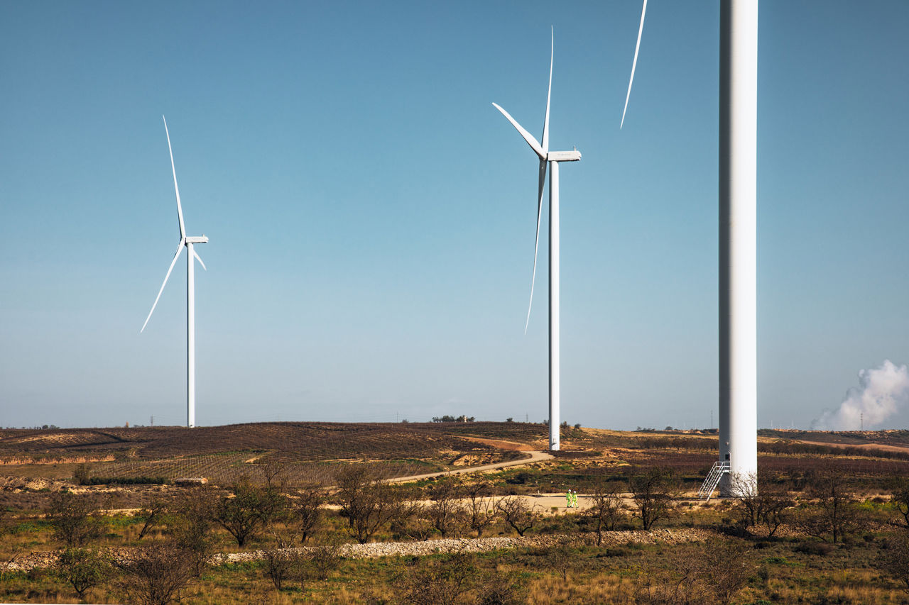 Three wind turbines in a hilly Scottish landscape