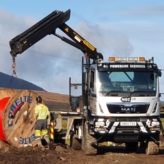 Picture of a white construction van outside at a windfarm