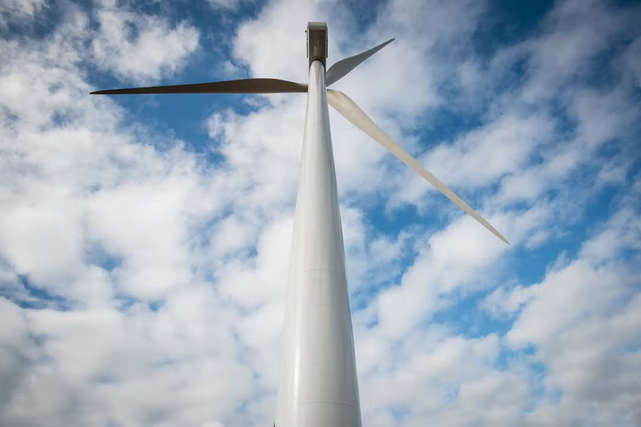 A wind turbine photographed from near its base